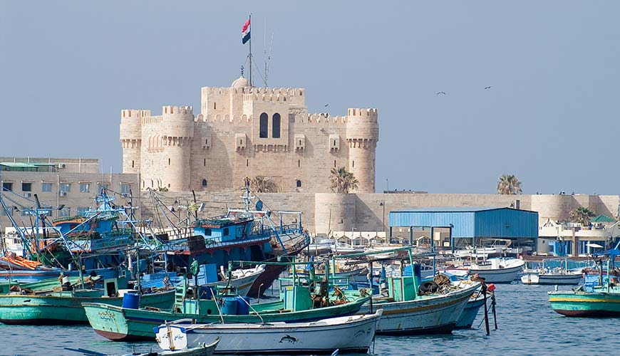 Boats and a castle where the lighthouse of alexandria once stood in Egypt. One of the 7 ancient wonders of the world