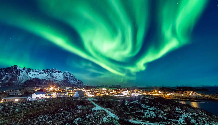 Aurora borealis northern lights in iceland above a small town