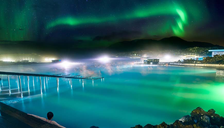 aurora borealis northern lights above the blue lagoon hot spring in iceland at night